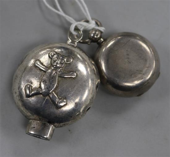 A late Victorian silver sovereign case and a later childs silver rattle (parts missing).